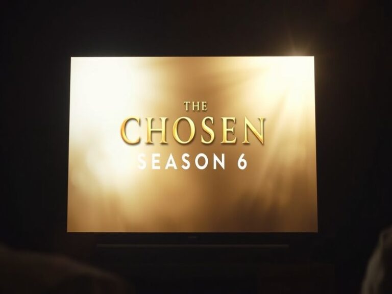 A cinematic promotional image of the disciples gathered around Jesus under a warm sunset sky, with ancient Jerusalem in the b