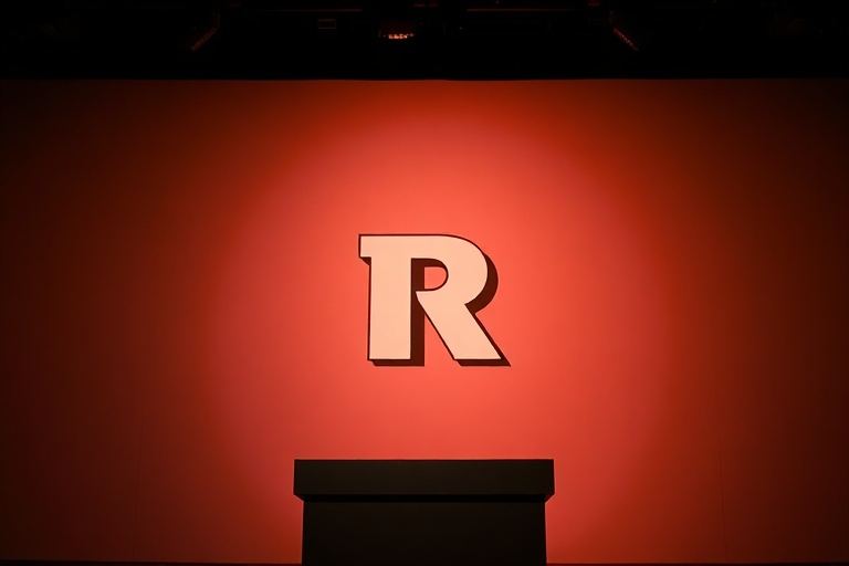 A dark, yellow-lit hallway stretching into infinite darkness, with flickering fluorescent lights and a VHS camera recording t